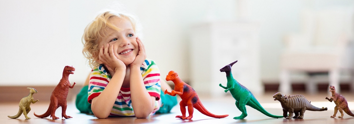 child playing with dinosaur toys